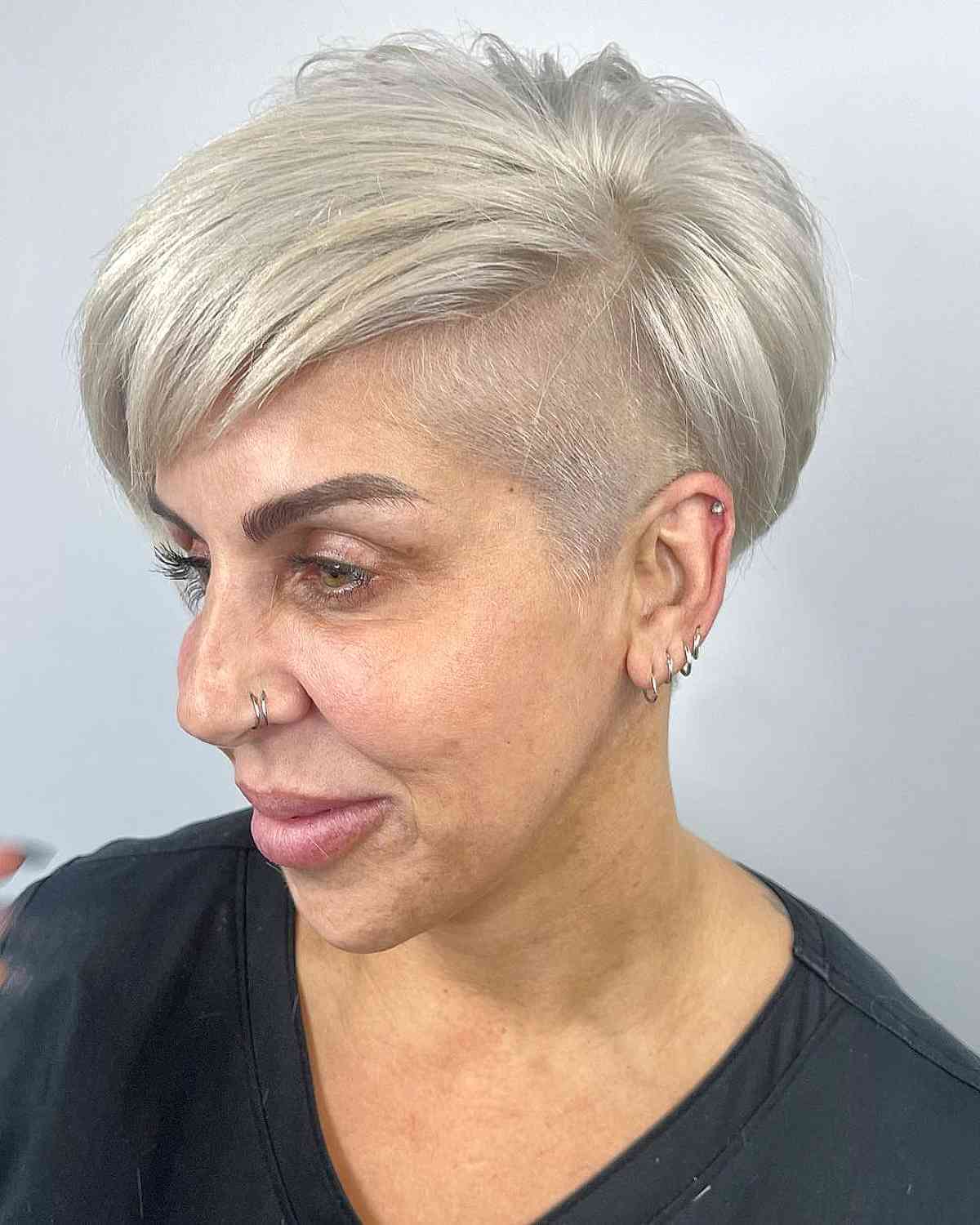 Platinum pixie with undercut sides and longer top layers.