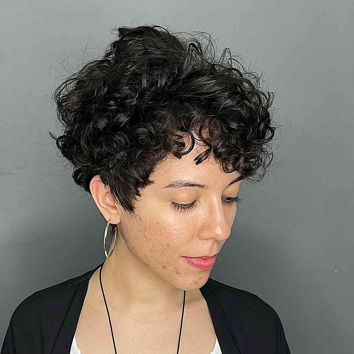 Short curly pixie with tapered sides and full top