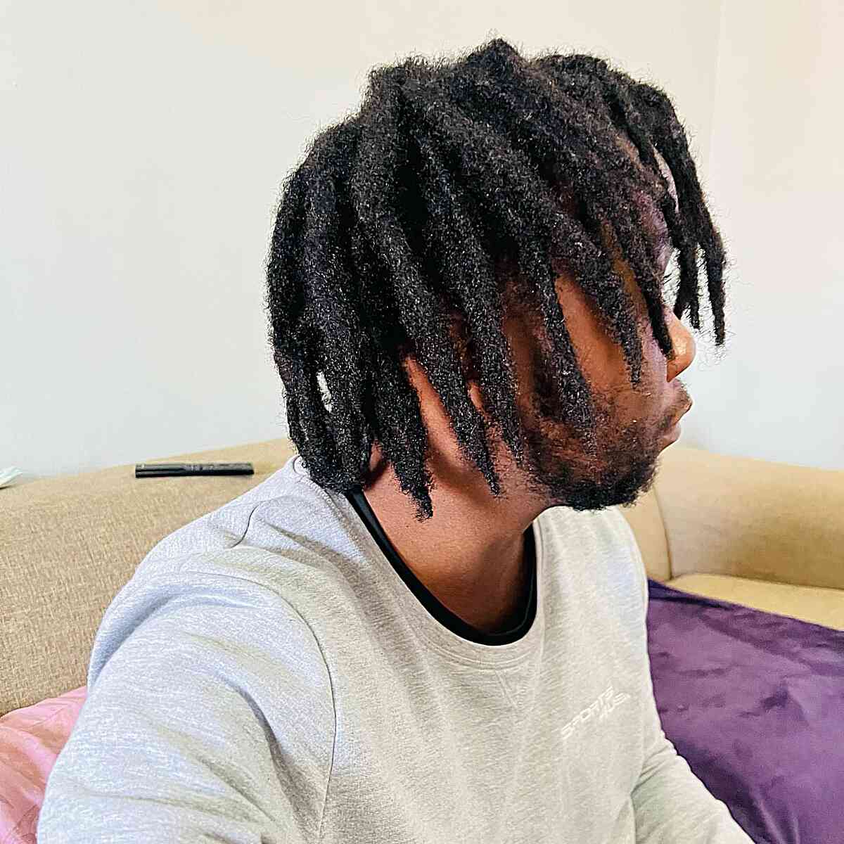 Medium-length freeform locs with loose separation and natural movement.
