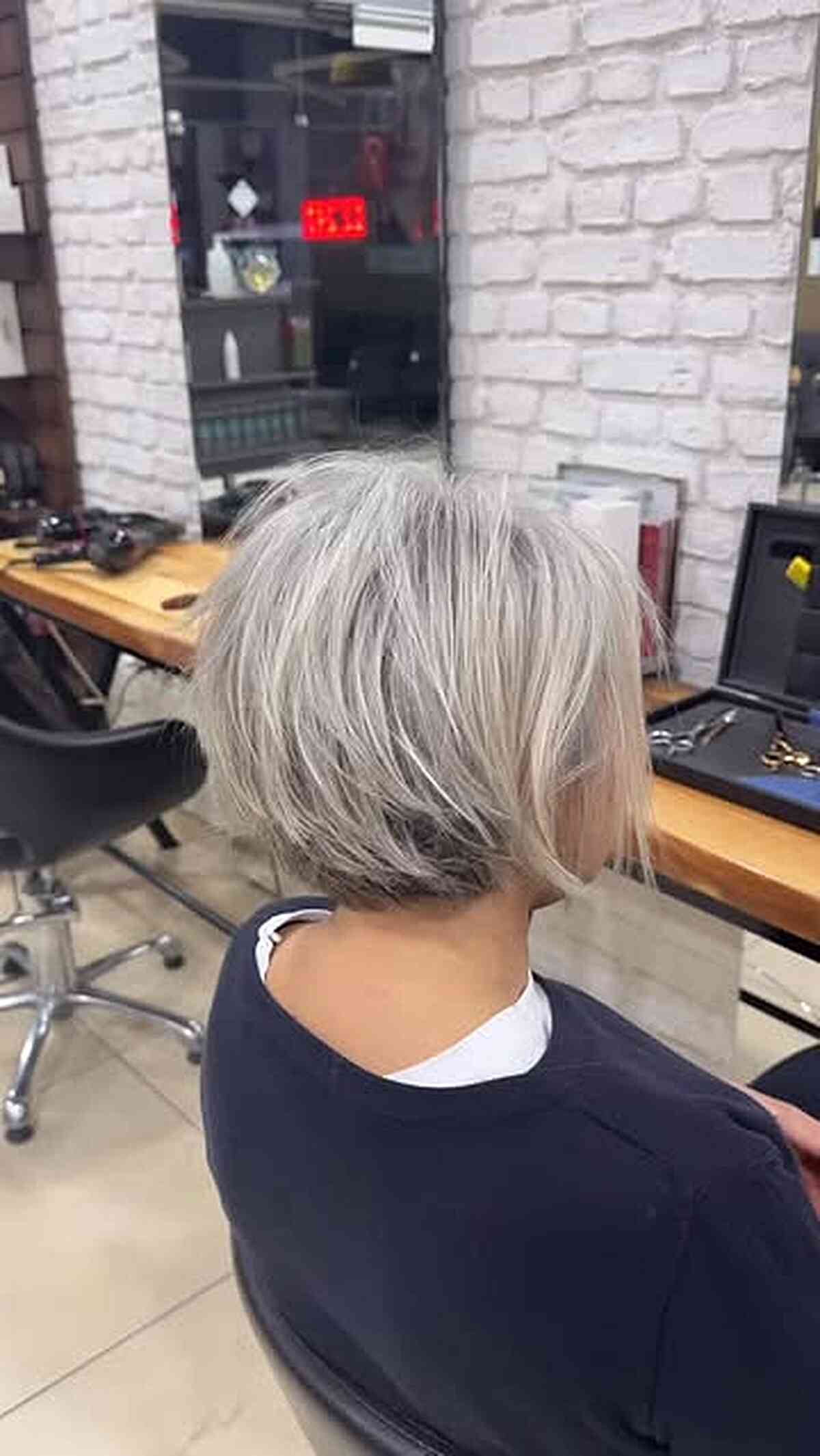 Short silver bob with textured ends and a tapered back.