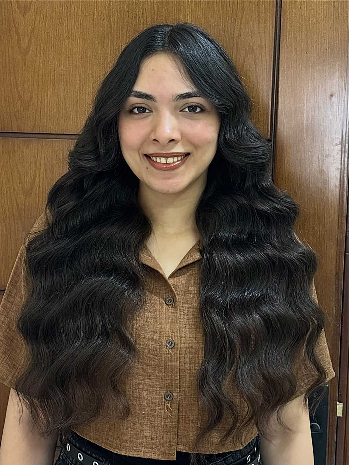 Ultra-long black hair with defined S-shaped waves and a center part.